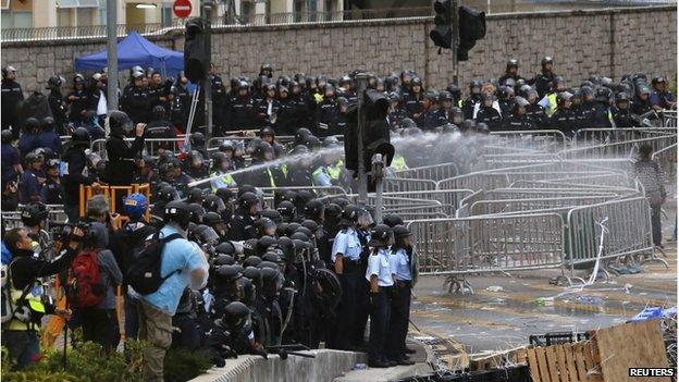 Riot police use a water cannon to disperse protesters during clashes outside the government headquarters in Hong Kong 1 December 2014