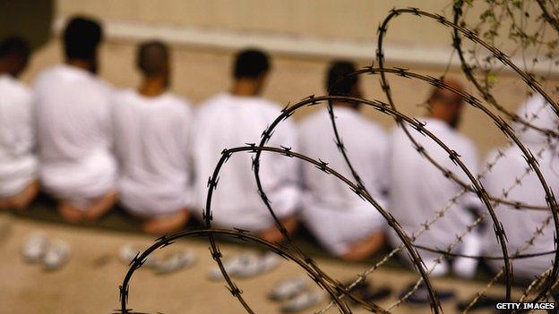 A group of detainees kneels in Guantanamo Bay, Cuba, on 28 October 2009