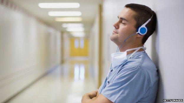 Surgeon listening to music on headphones