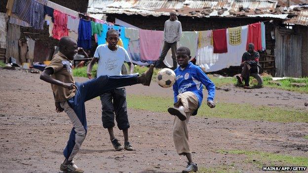 Boys play football on a dusty patch in Majengo slum in the outskirts of Nairobi.