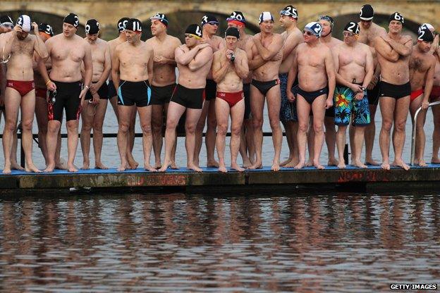 Swimmers prepare to dive into London's Serpentine Lake, Christmas 2011