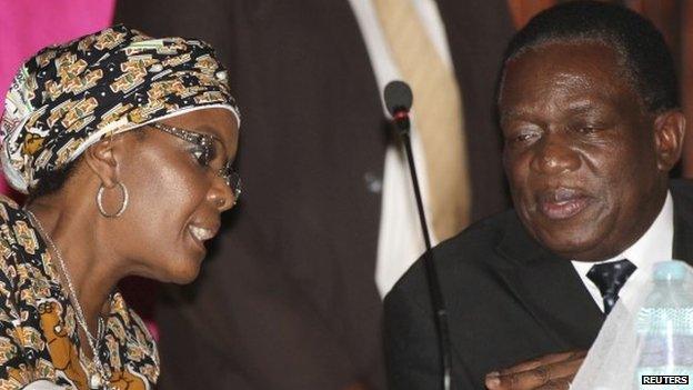 Grace Mugabe, wife of Zimbabwean President Robert Mugabe, talks to Vice-President Emmerson Mnangagwa (R) in Harare on 10 December 2014