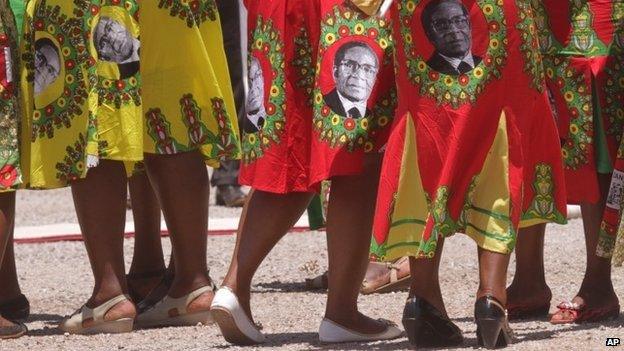 Supporters of Zimbabwean President Robert Mugabe sing and dance while waiting for his arrival on the last day of the Zanu-PF 6th National Congress in Harare on 6 December 2014