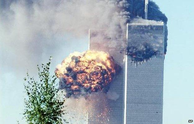 A fireball erupts from one of the World Trade Center towers in New York City after being hit by a passenger plane hijacked by al-Qaeda members (11 September 2001)