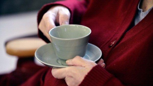 Elderly people enjoy refreshments at the Age UK Centre in Barnet, England, 2013