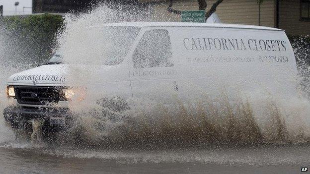 A van navigates a flooded roadway in Berkeley, California 11 December 2014