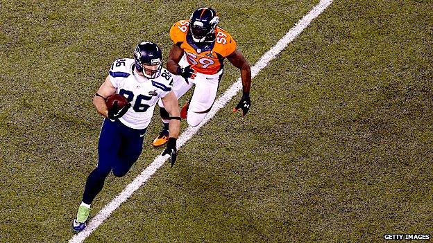 Zach Miller of the Seattle Seahawks tries to avoid the tackle of outside linebacker Danny Trevathan of the Denver Broncos during Super Bowl XLVIII in 2014