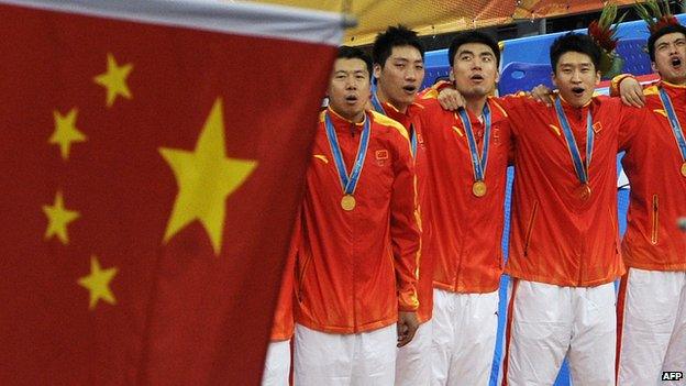 Gold medallists from China sing the national anthem during the award ceremony for the men's basketball gold medal match at the 16th Asian Games in Guangzhou on November, 2010.