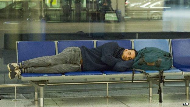 A passenger lying down at Gatwick