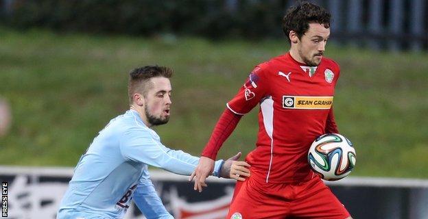 Institute's Robbie Hume closes in on Tomas Cosgrove of Cliftonville