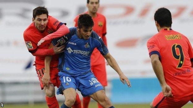 Lionel Messi vies with Getafe midfielder Pablo Sarabia