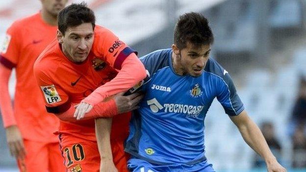 Lionel Messi vies with Getafe midfielder Pablo Sarabia