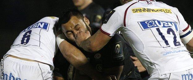 Bill Vunipola feels the pain as two defenders converge on him