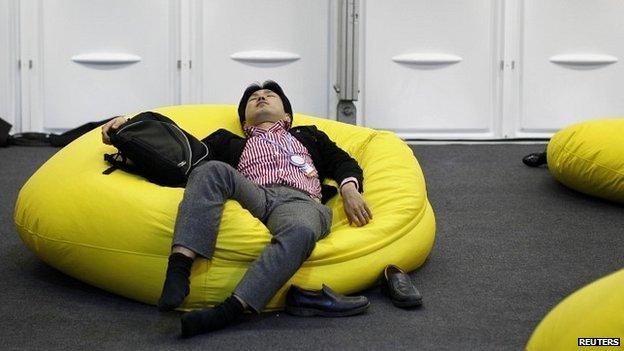 A delegate rests during a break at the UN climate change talks in Lima - 13 December 2014