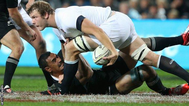 Joe Launchbury tries to power past the grounded Jerome Kaino