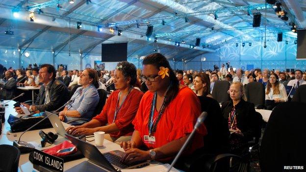 Delegates listen as COP 20 President and Peru's Environment Minister Manuel Pulgar Vidal speaks at the talks