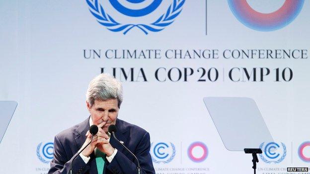 US Secretary of State John Kerry gestures while delivering a speech at the UN Climate Change Conference.