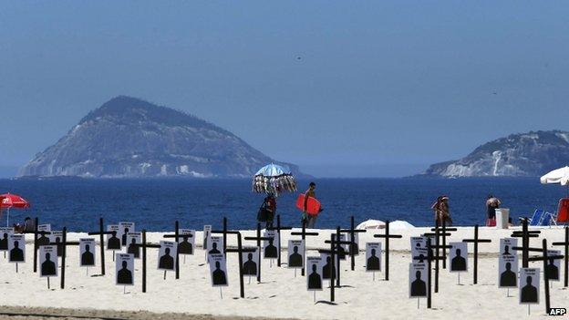 Crosses on Copacabana beach, police protest 9 Dec 14