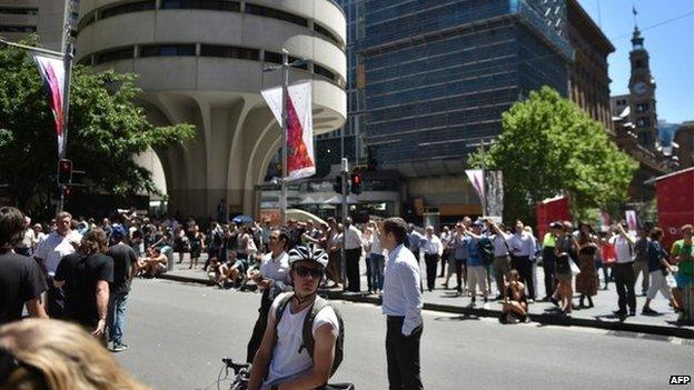 Onlookers gather in Martin Place in the central business district of Sydney on December 15, 2014.