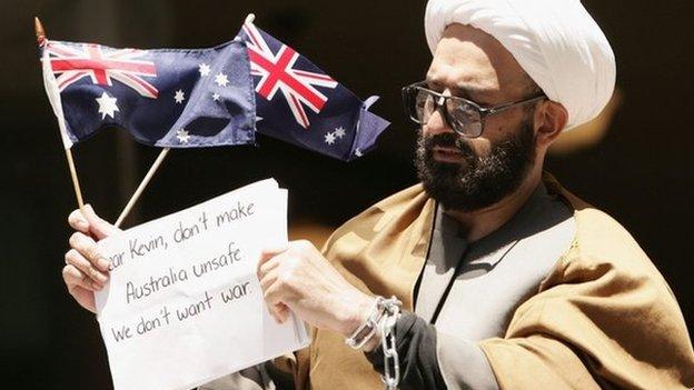 Man Haron Monis holds an Australian flag outside Downing Centre Local Court after having been charged over letters harassing families of Australian soldiers in Sydney, Australia, 10 November 2009.