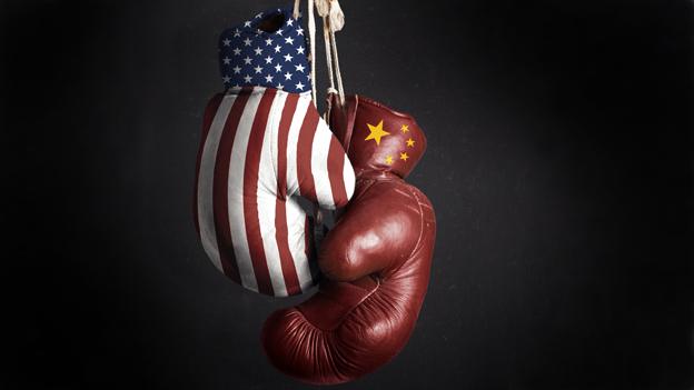 Two boxing gloves - one with the US flag and the other with the Chinese flag