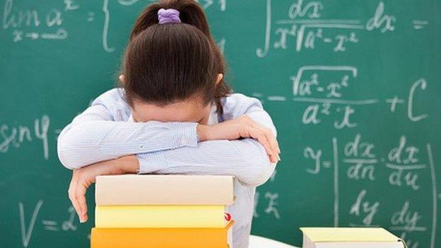 Student with math books in classroom