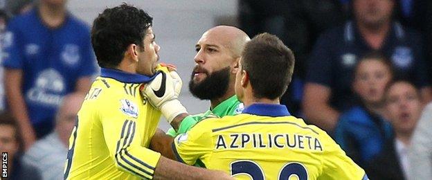 Everton goalkeeper Tim Howard grabs Diego Costa (left)