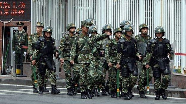 This file picture taken on on 23 May 2014 shows fully armed Chinese paramilitary police patrol a street in Urumqi, the capital of farwest China's Muslim Uighur homeland of Xinjiang.