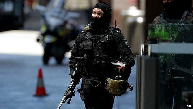 An armed policeman is seen in Phillip St on December 15, 2014 in Sydney, Australia. Police attend a hostage situation at Lindt Cafe in Martin Place.