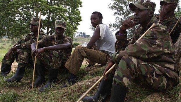 Members of the former Congolese M23 rebels sit at a compound in Uganda's Bihanga Training School, about 380km south-west of the capital Kampala, on 7 February 2014
