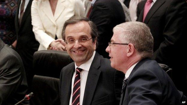 Sunday, June 17, 2012 file photo, New Democracy leader Antonis Samaras, centre, smiles prior to a press conference in Athens