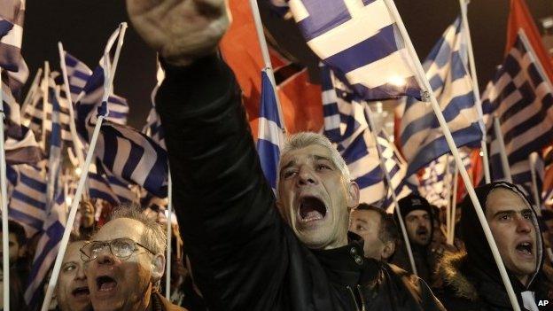 Feb. 1, 2014 file photo of a supporter of Greece"s extreme right party Golden Dawn as he raises his hand in a Nazi-style salute during a rally in Athens