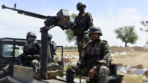 Cameroonian soldiers patrol on 12 November 2014 in Amchide, northern Cameroon, 1 km (1.6 mi) from Nigeria.