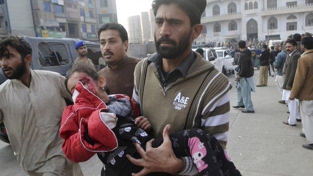 A Pakistani girl, who was injured in a Taliban attack in a school, is rushed to a hospital in Peshawar, Pakistan, 16 December 2014