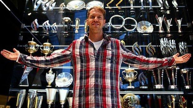 Sebastian Vettel with the trophy cabinet at Red Bull