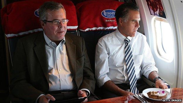 Jeb Bush and Mitt Romney sit together on a campaign plane in 2012.