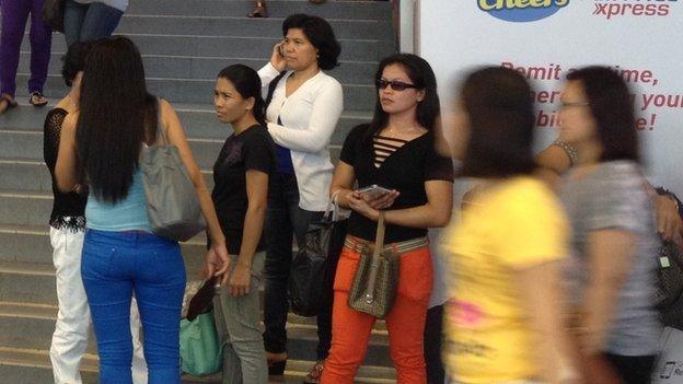 Picture of people at Lucky Plaza, a Filipino hub in Singapore