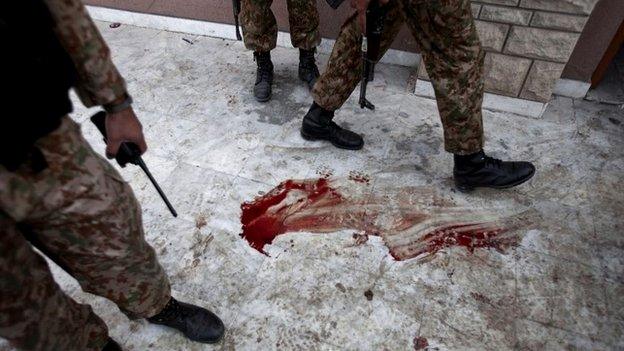 Pakistan army soldiers stand outside the auditorium of a school that was attacked by Taliban militants in Peshawar, Pakistan - 17 December 2014