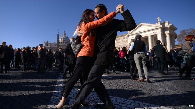 Tango enthusiasts dance on the Via della Conciliazione in front of St Peter"s square to celebrate Pope Francis 78th birthday during his general audience on December 17, 2014 in Rome