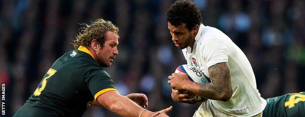 Courtney Lawes takes on South Africa's Jannie Du Plessis