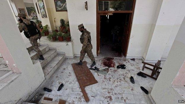 Pakistani security officials inspect the premises of the Army Public School that was attacked by Taliban militants in Peshawar - 17 December 2014