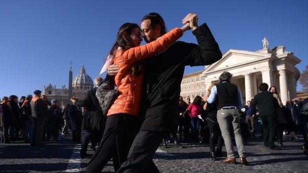 Tango enthusiasts dance on the Via della Conciliazione in front of St Peter"s square to celebrate Pope Francis 78th birthday during his general audience on December 17, 2014 in Rome