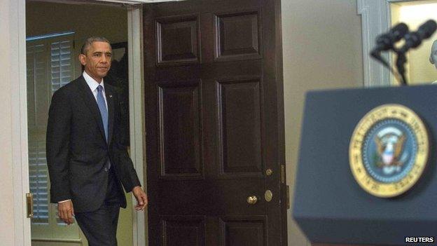 Barack Obama arrives in the White House Cabinet Room on 17 December, 2014.