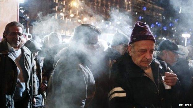 Pensioners receive free food as part of a night-long anti-austerity protest in Athens (10 December 2014)