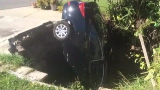 A car swallowed by a hole in a drive in Florida