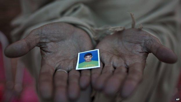 Pakistani Sayed Shah, shows a picture of his son Zulqarnain, 17, a student who was killed in last Tuesday's Taliban attack on a military-run school, in Peshawar, Pakistan, Thursday, Dec. 18, 2014.