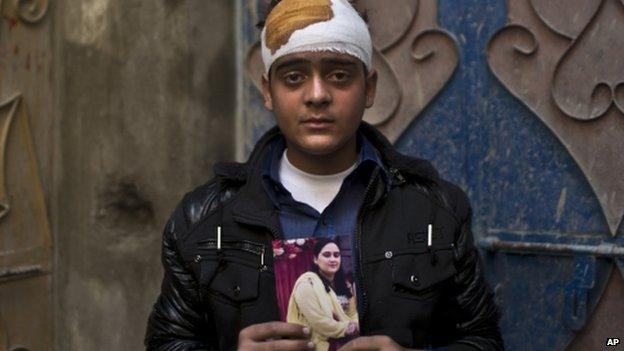 Baqir Jafri, a survivor of the Peshawar school massacre, holds a photo of his mother