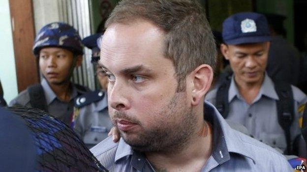 New Zealand citizen Philip Blackwood is escorted by policemen after a hearing at a court, Yangon, Myanmar