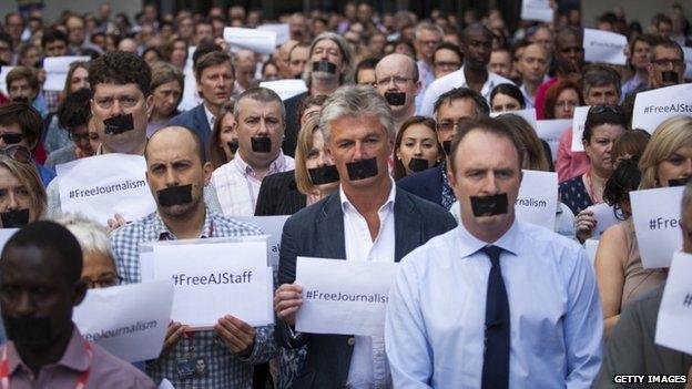 BBC journalists hold one-minute silent protest outside New Broadcasting House against the seven-year jail terms given to three al-Jazeera journalists in Egypt on 24 June 2014 in London, England.