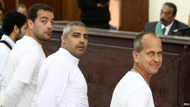 Australian journalist Peter Greste (R), Canadian-Egyptian journalist Mohammed Fahmy (C) and journalist Baher Mahmoud (L) standing in front of the judge"s bench during their trial on 31 March 2014